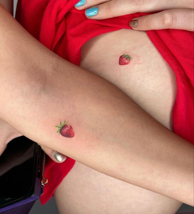 a woman's legs with small strawberry tattoos on her thighs and the bottom half of her leg