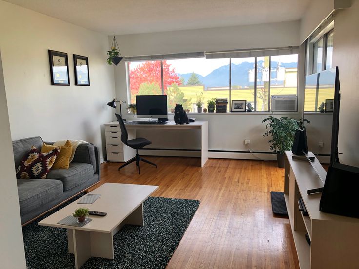 a living room filled with furniture and a flat screen tv