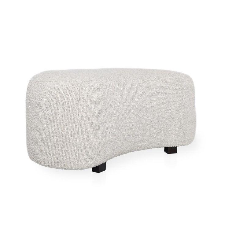 a white ottoman with black legs on a white background