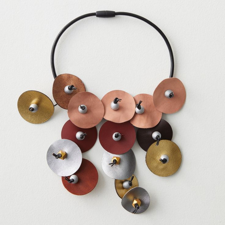 Mixed-Media Necklace - This earth-toned necklace showcases graduating colors of rust, salmon, maroon, silver and gold, constructed from leather disks and coconut shell, all hand-knotted on a leather collar bib. Magnetic clasp closure. Pottery Jewellery, Leather Statement Necklace, Mixed Media Necklace, Leather Necklaces, Queen Jewelry, Leather Jewellery, Polymer Crafts, Leather Art, Artful Home