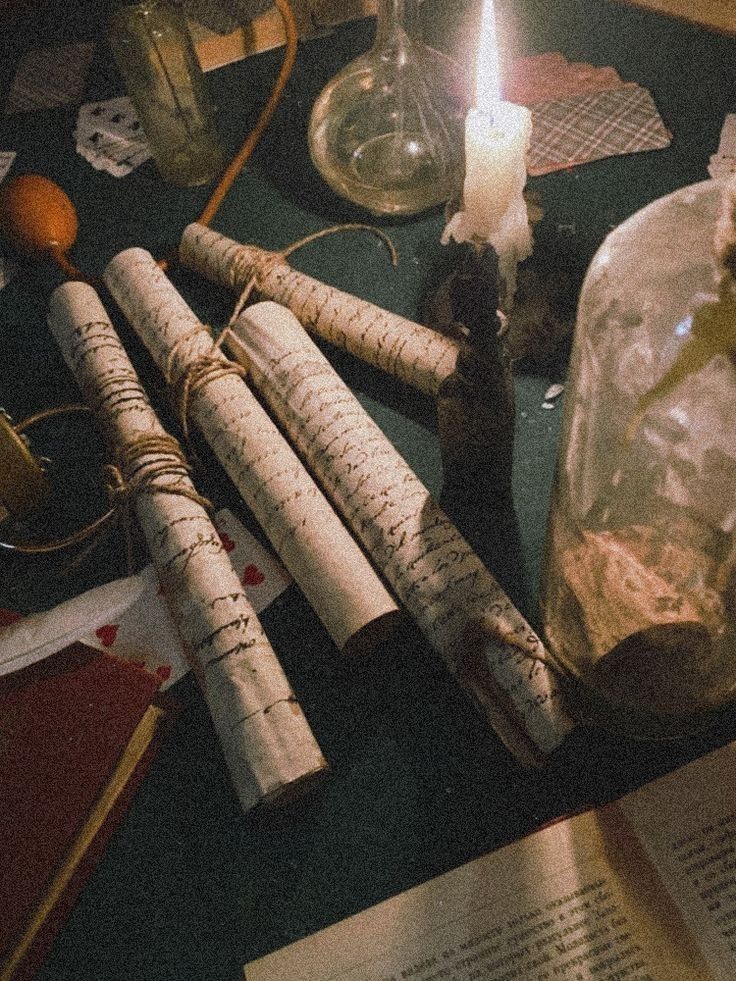 the table is cluttered with books, candles, and other items that are on it