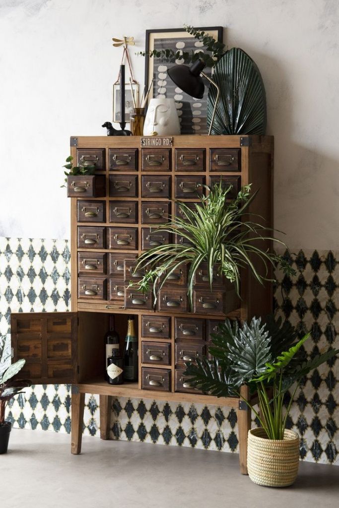 a wooden shelf filled with lots of potted plants next to a wall mounted clock