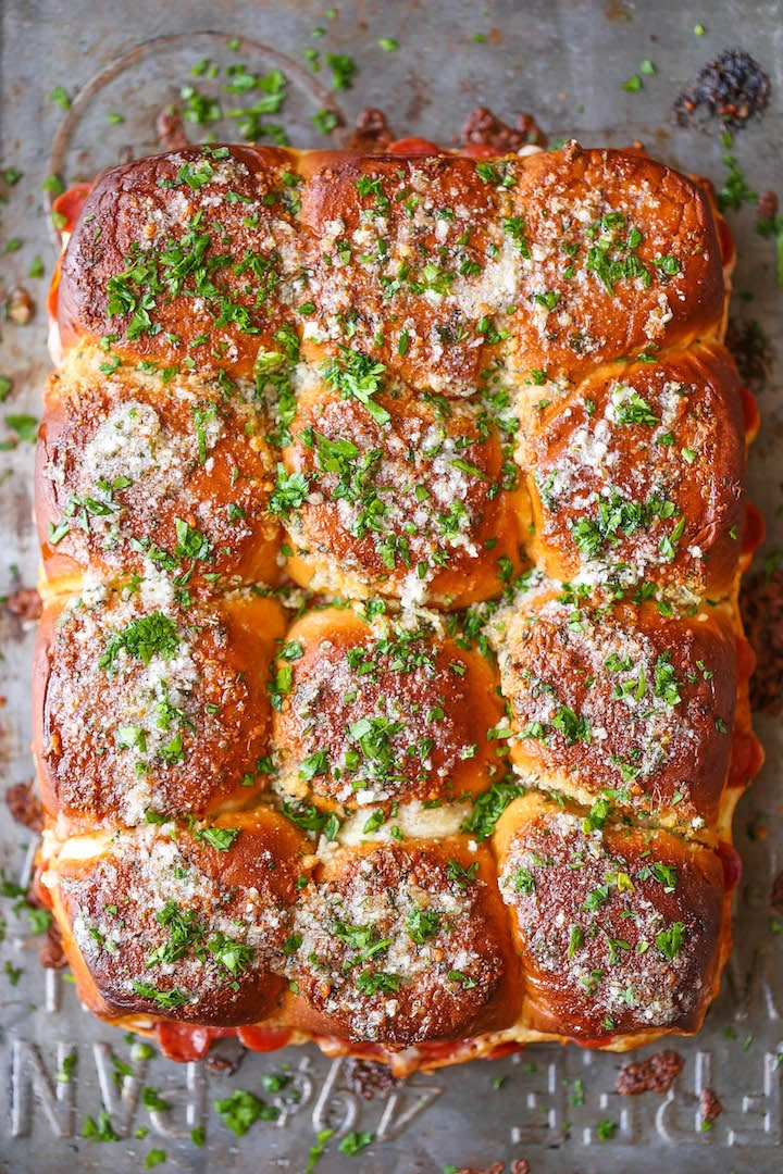 a casserole dish filled with meatballs and parmesan cheese on top