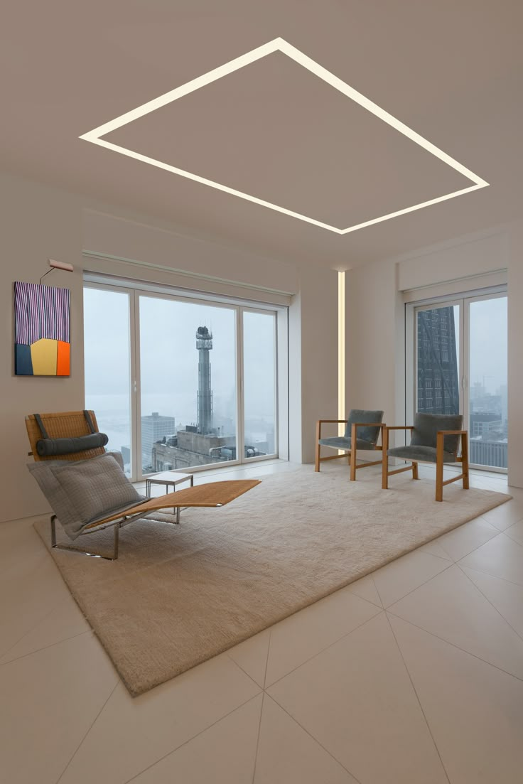 an empty living room with large windows overlooking the city