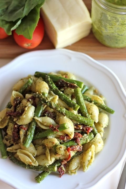 a white plate topped with pasta and green beans