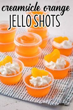 orange jello shots with whipped cream on top