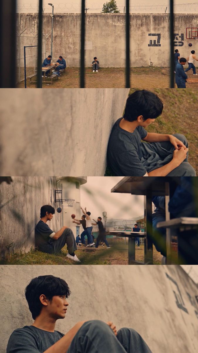 a man sitting on top of a skateboard ramp