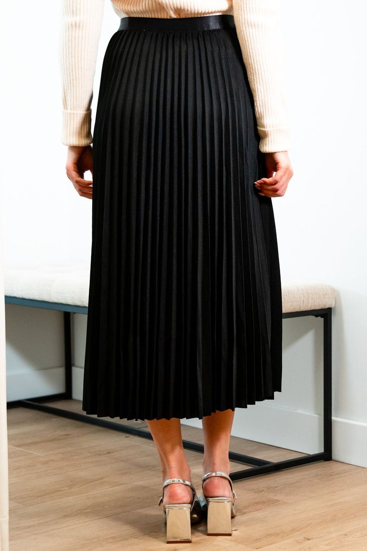 Get ready for an evening out with our Victoria skirt. Featuring a luxurious black accordion pleated design, this midi length skirt exudes elegance and refinement. Elevate any outfit with this chic and sophisticated piece. Elastic satin waistband Mary Grace is wearing XS/S with a 32B bust, 25” waist and 36” hip. 95% Polyester, 5% Spandex Hand wash cold and line dry Sleek Midi Skirt For Fall, Evening Midi Length Pleated Skirt, Evening Midi-length Pleated Skirt, Date Night Lined Midi Skirt, Chic Flowy Maxi Skirt With Folds, Midi Skirt With Folds For Party, Chic Maxi Skirt With Folds, Party Midi Skirt With Folds, Elegant Flowy Maxi Skirt With Accordion Pleats