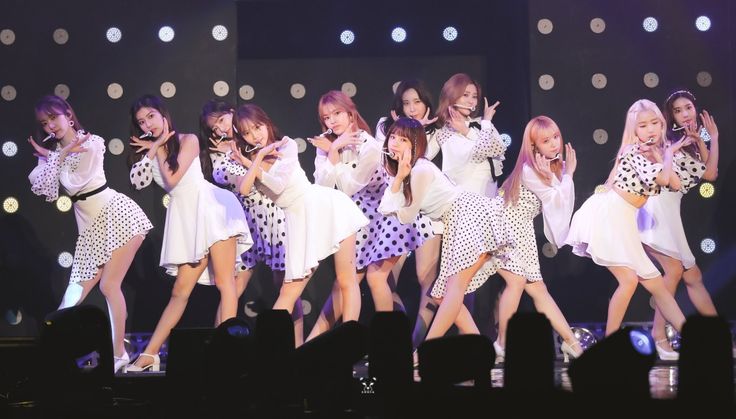 girls'generation performing on stage in white dresses with polka dot print skirts and heels