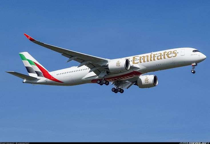 an emirates airplane is flying in the sky