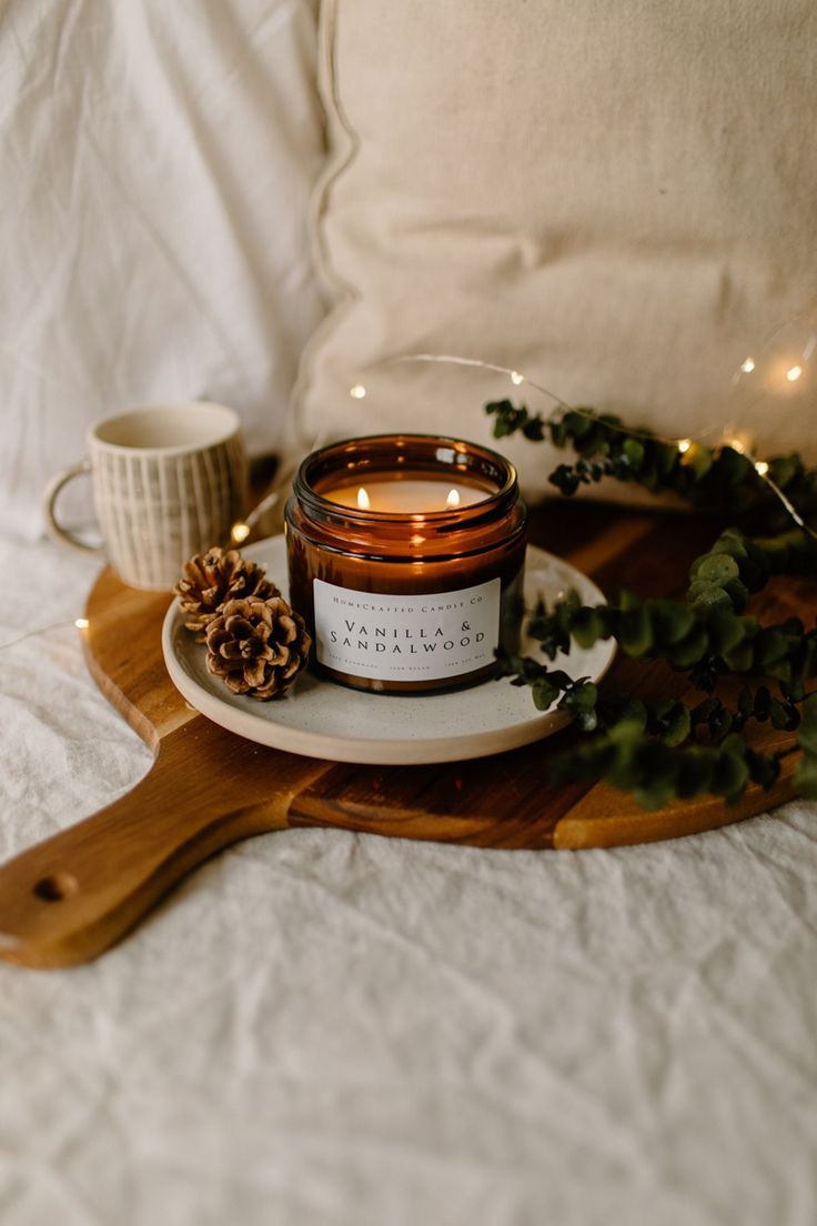 a candle sitting on top of a wooden tray