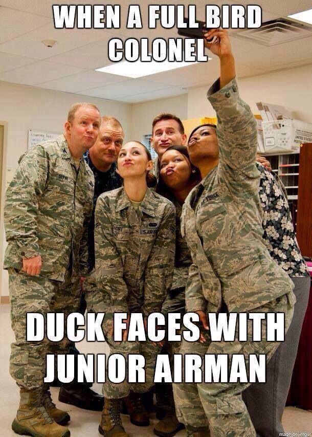 a group of people that are standing in front of a sign with the words, when a full bird colonel duck faces with a junior airman