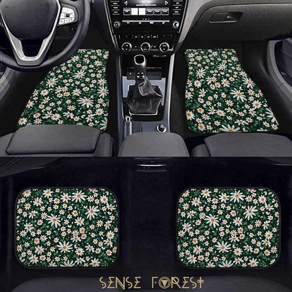 the interior of a car with flowers and plants all over it's floor mats