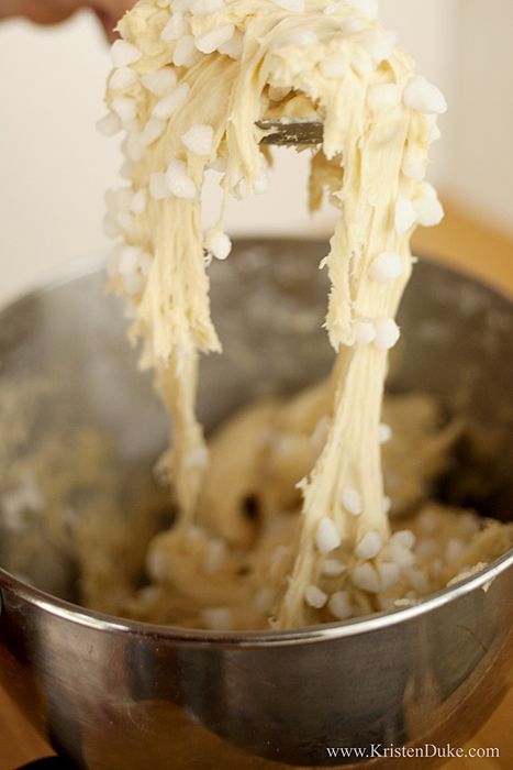 someone is mixing food in a metal bowl