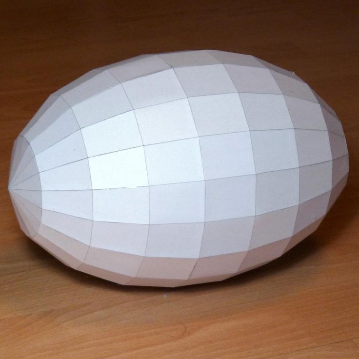 a white paper ball sitting on top of a wooden table