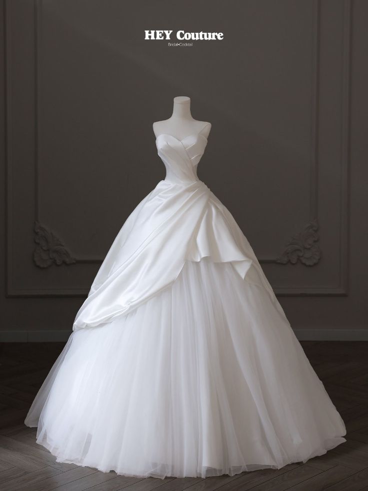 a white wedding dress on display with the words hey couture written above it