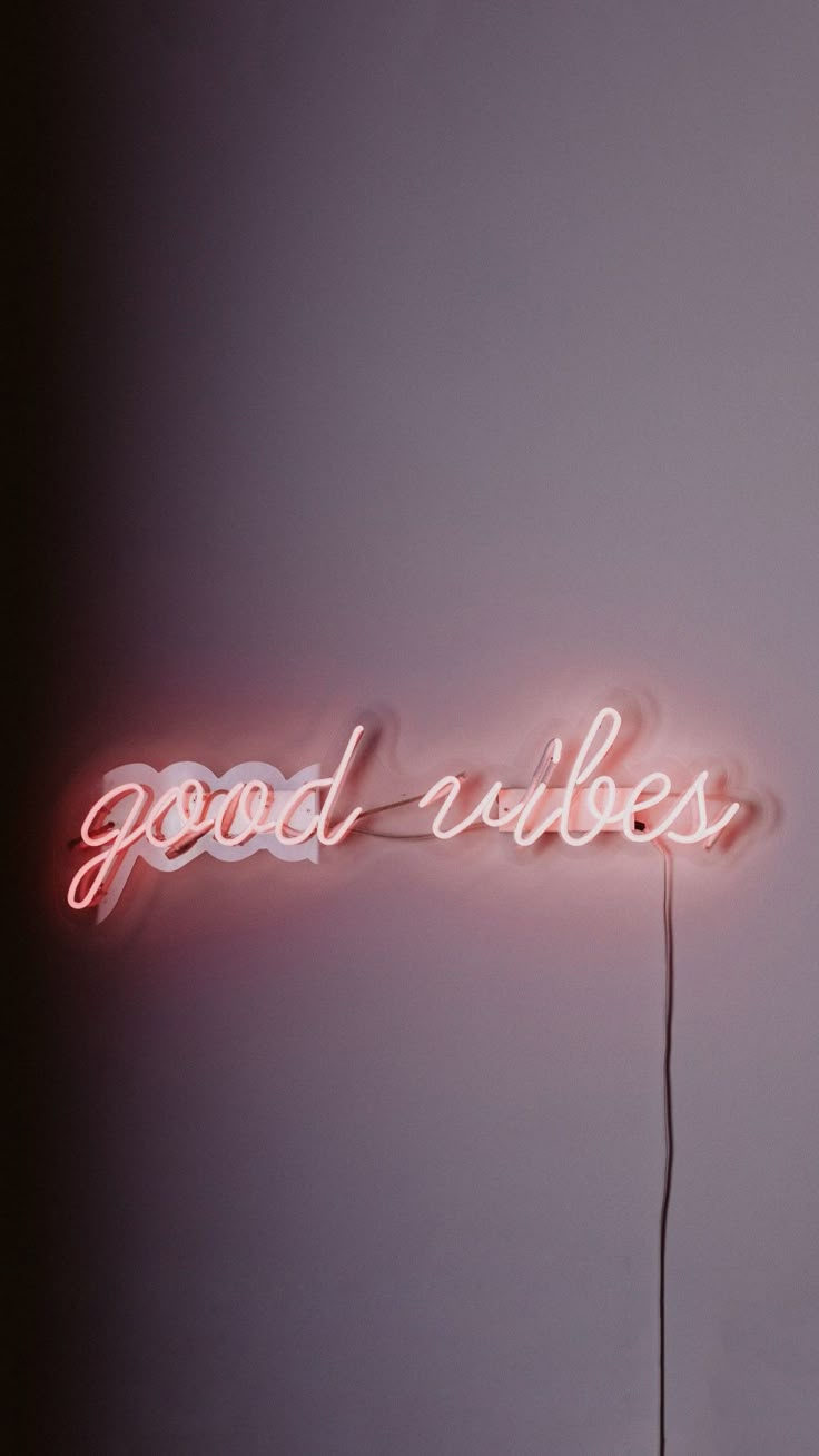 a neon sign that says good vibes on it