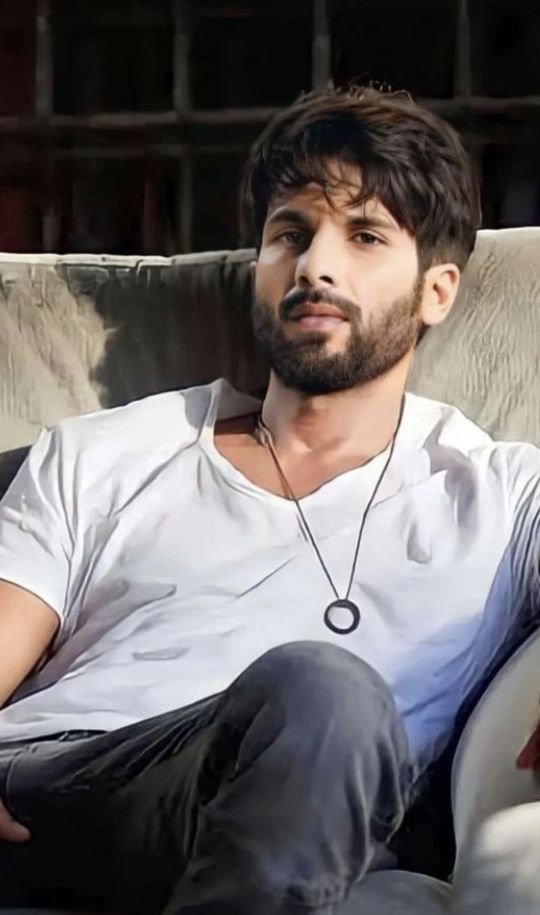 a man sitting on top of a white couch