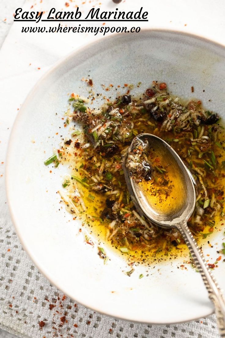 a white plate topped with food and a spoon