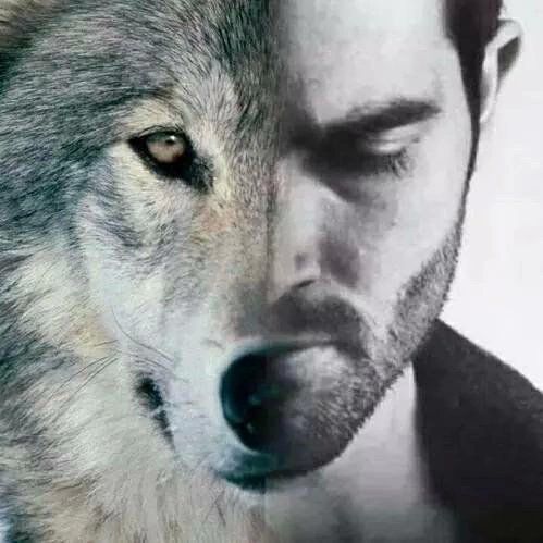 a close up of a person with a wolf on his shoulder and the image of a man's face behind him