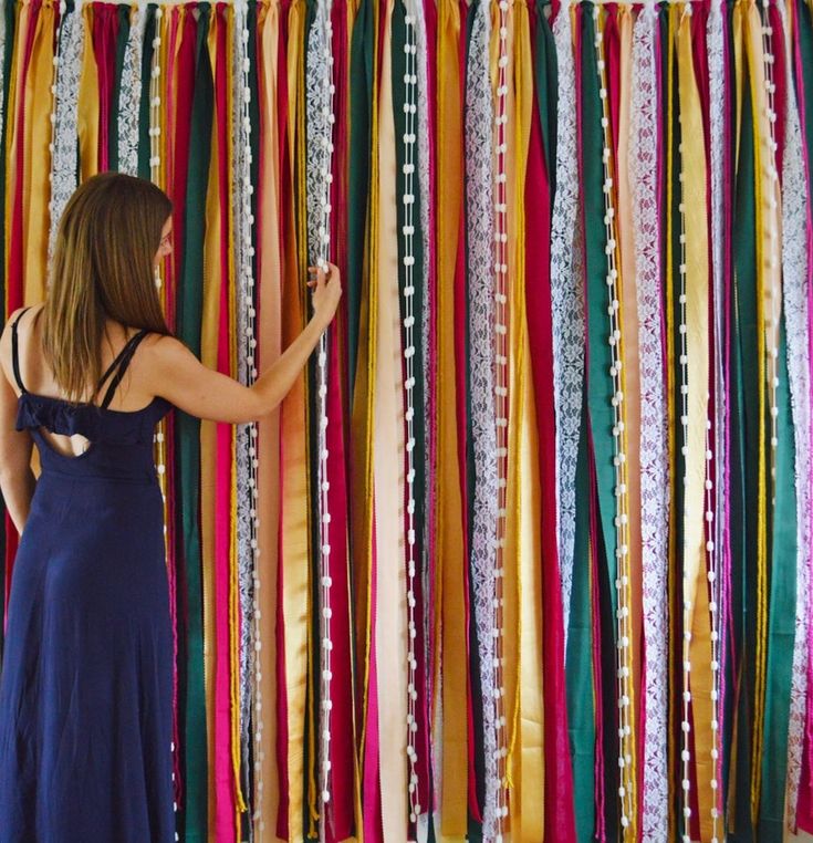 a woman standing in front of colorful streamers