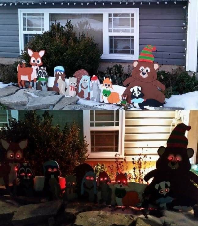 halloween decorations in front of a house with fake animals and pumpkins on the ground