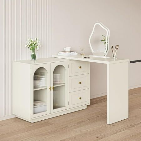 a white desk with two drawers and a mirror on the top shelf next to it