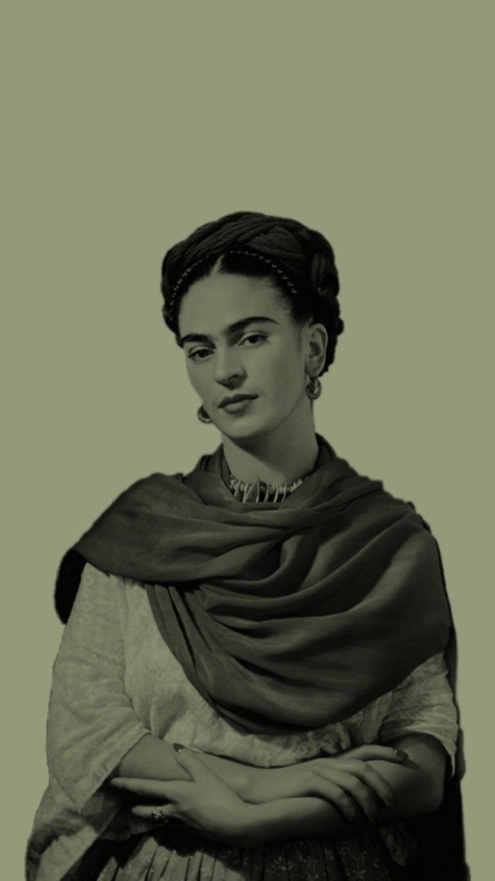 a black and white photo of a woman wearing a dress with a shawl over her shoulders