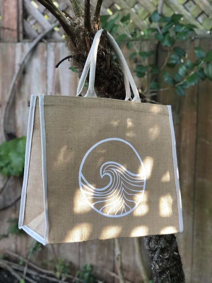 Large jute tote bag with hand painted wave design in white and natural woven handles and edge detailing. Small velcro patch to keep it closed. Perfect beach tote, for grocery shopping, or day trips. Eco-friendly Cream Beach Bag, White Rectangular Jute Beach Bag, White Jute Beach Bag For Everyday Use, White Jute Beach Bag For Daily Use, Eco-friendly White Jute Beach Bag, White Jute Bags, Eco-friendly White Jute Bags, Eco-friendly White Canvas Beach Bag, Eco-friendly White Tote Beach Bag