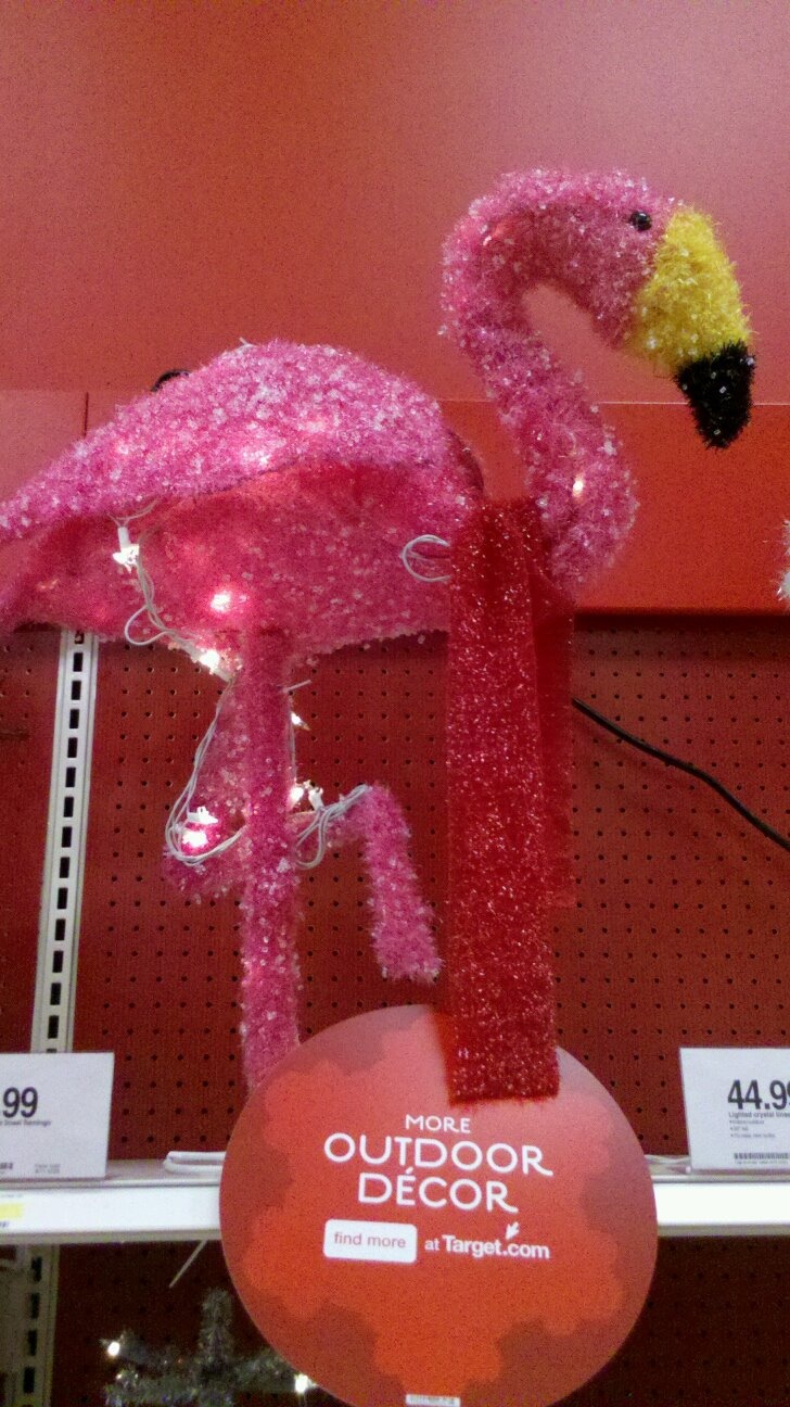 a pink flamingo decoration is on display for sale at a store in the usa