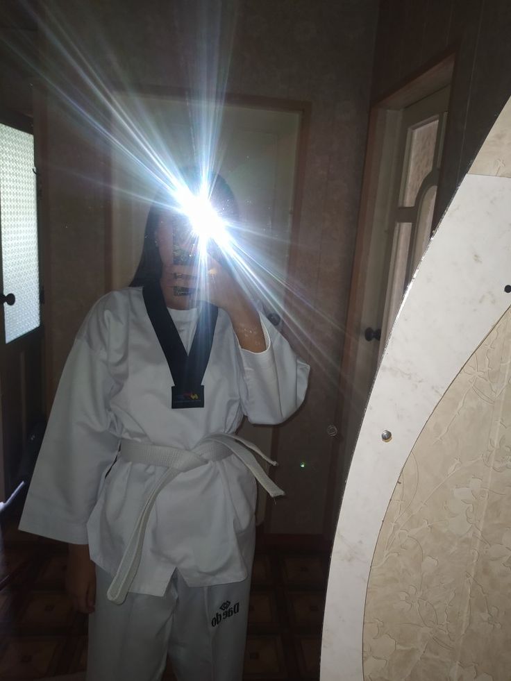 a person taking a selfie in the mirror with a light shining on their face