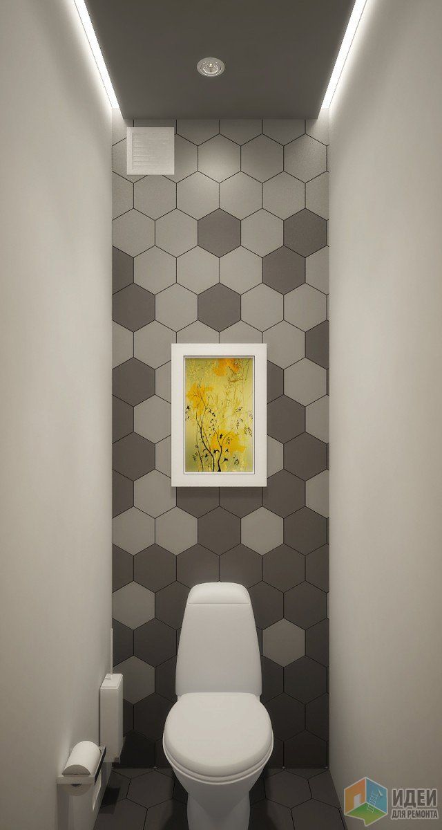 a white toilet sitting in a bathroom next to a painting on the wall above it