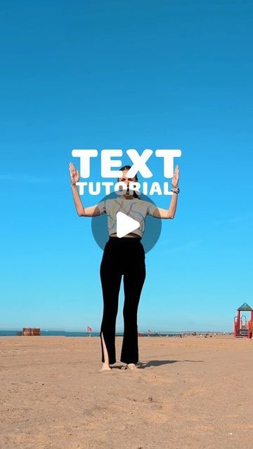 a woman standing on the beach holding up a sign that says text material in front of her head