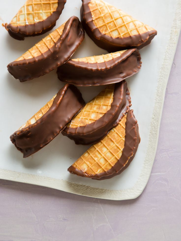 chocolate covered waffles are arranged on a plate