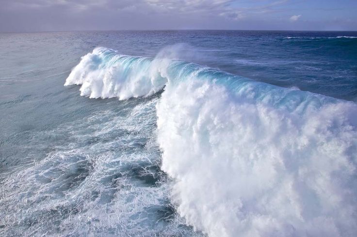 a large wave is breaking over the ocean