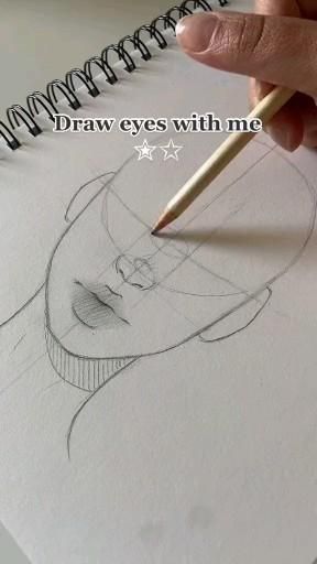 a person drawing with a pencil on top of a piece of paper that says draw eyes with me