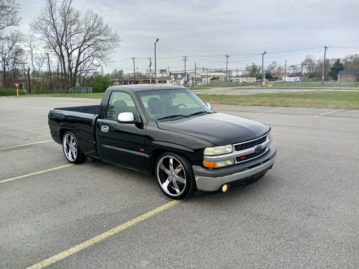 a black truck parked in a parking lot