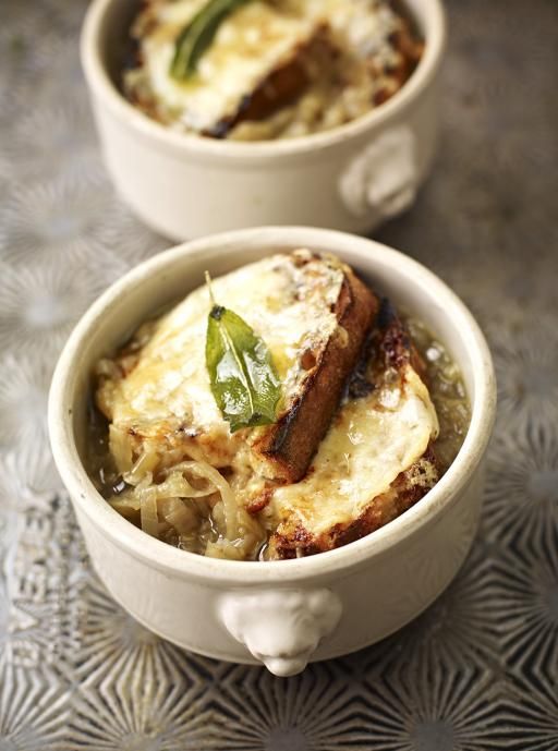 two white bowls filled with food on top of a table