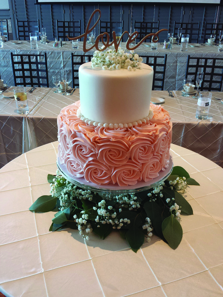 a three tiered wedding cake with flowers on the top is displayed in an instagram post