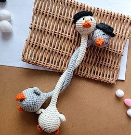 two crocheted birds are on the table next to some candies and candy