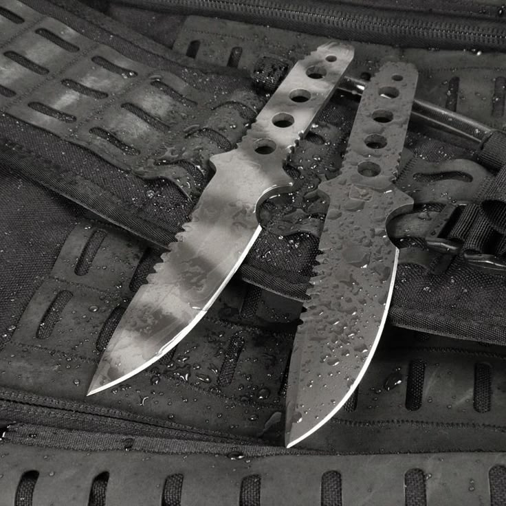 several knives are laying on top of each other in an open case with rivets