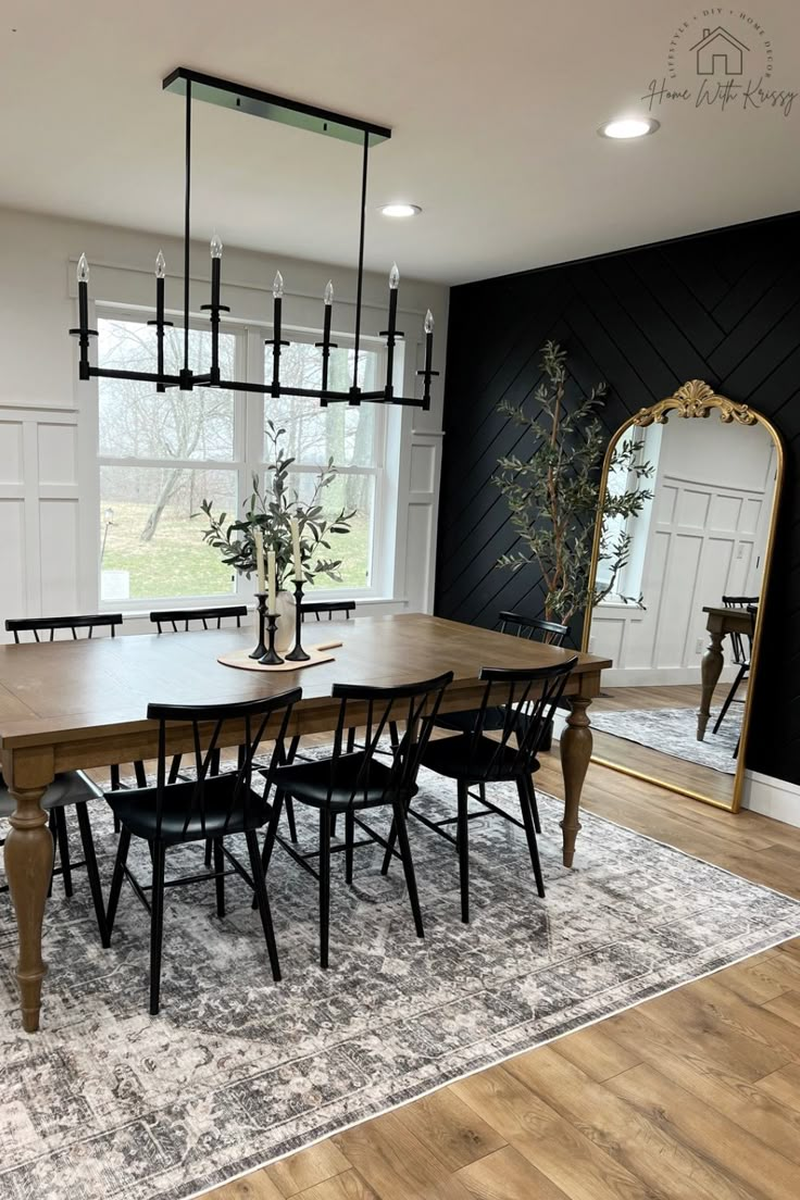 a dining room table with six chairs and a mirror in the corner next to it