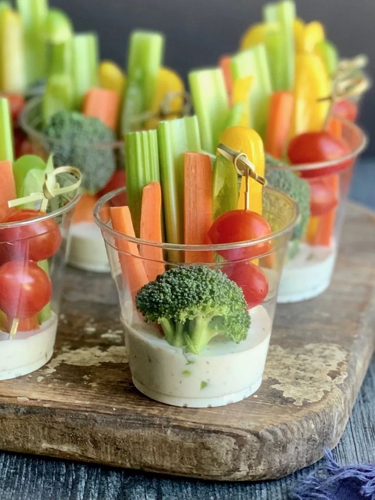 small cups filled with veggies and dip