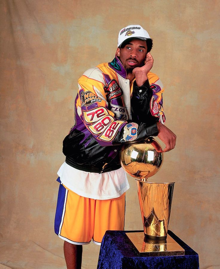 a man standing next to a golden trophy