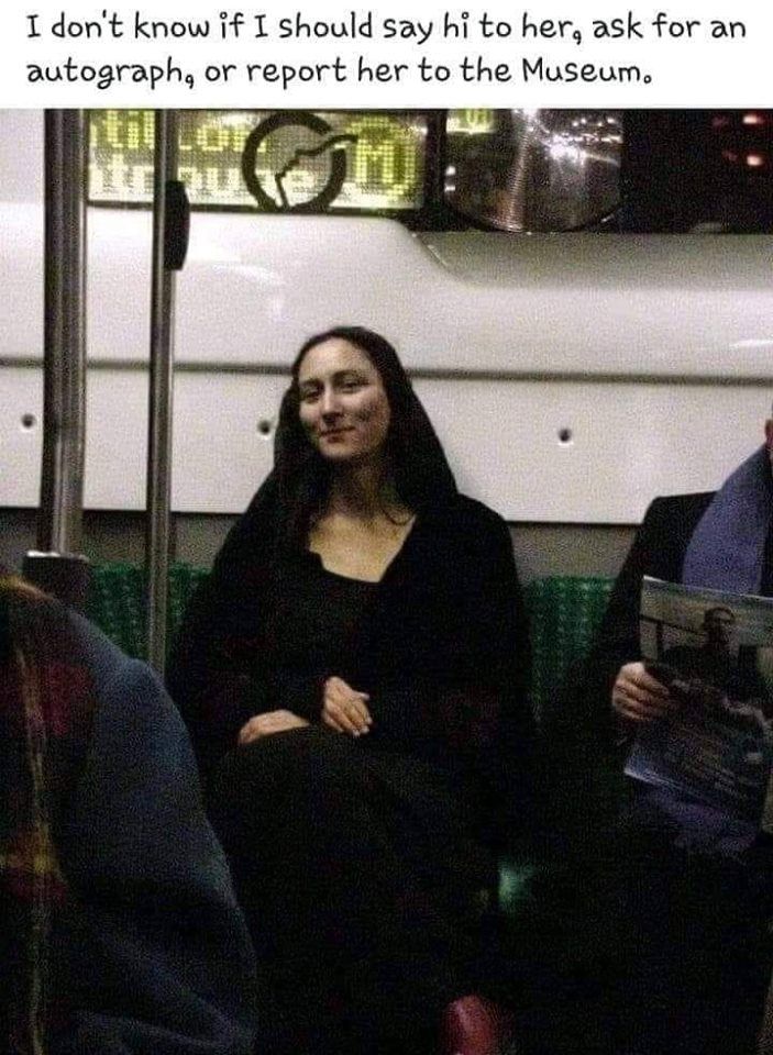 two people sitting on a subway train next to each other and one person holding a magazine