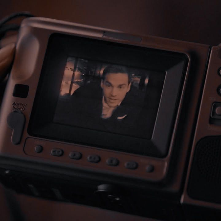 a man is on the screen of a video camera with his hand in front of him