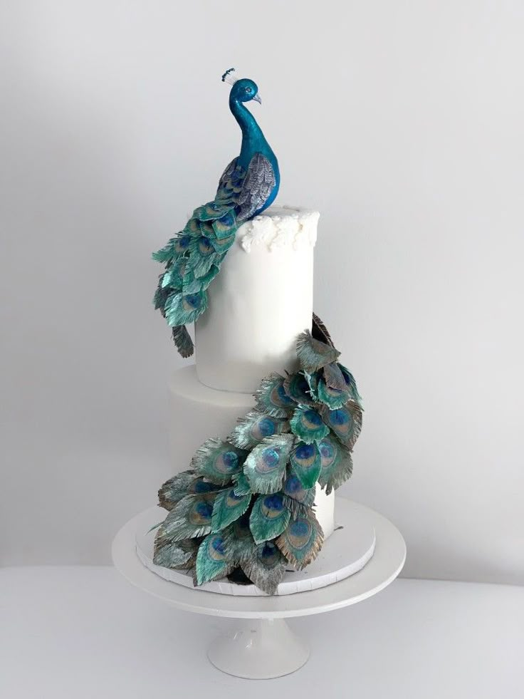 a white cake with peacock decorations on top