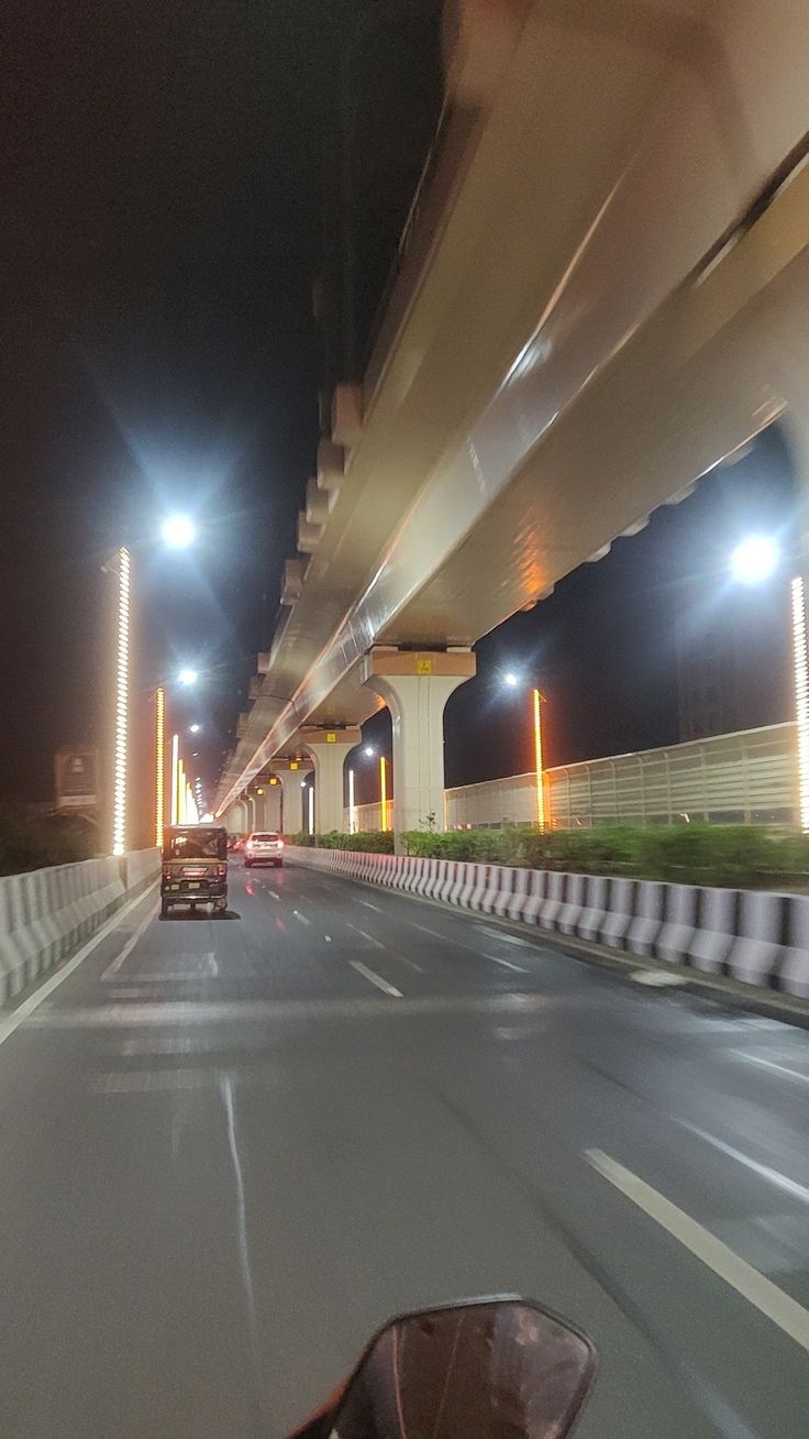 a car driving down a highway at night