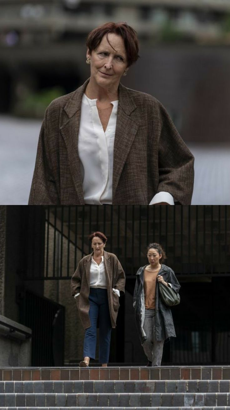 two women walking up some steps and one is wearing a brown jacket with white shirt