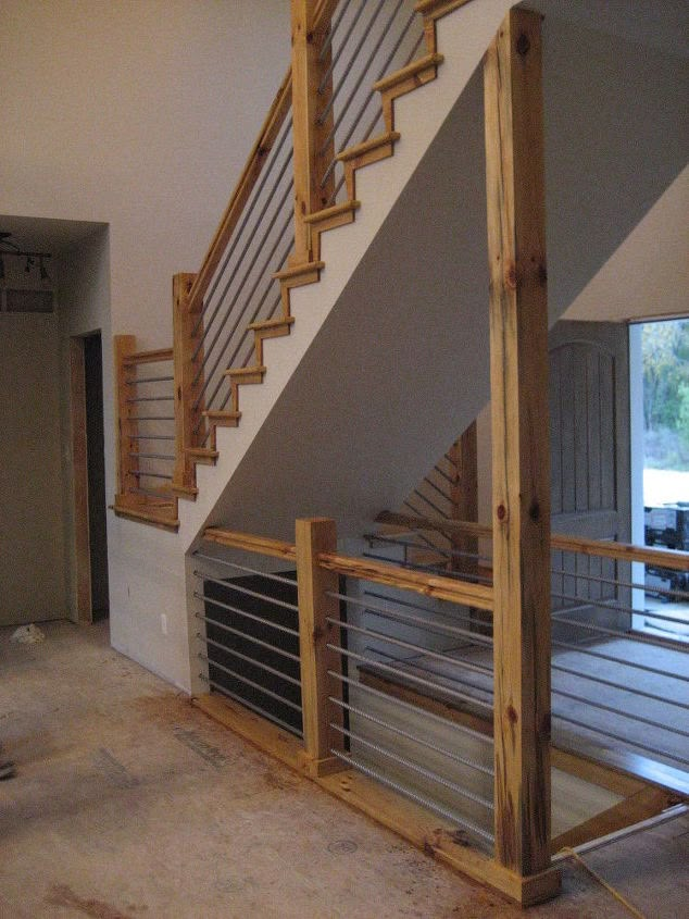 an empty room with stairs and railings in the process of being renovated by someone else